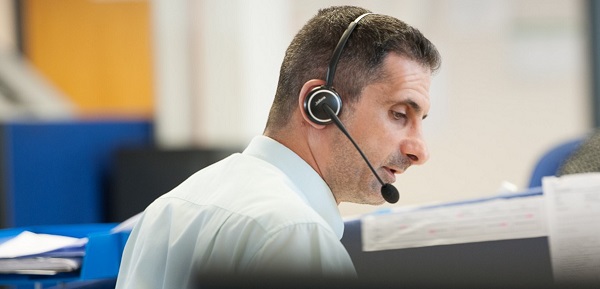 AutoProtect claims engineer, male, headset, office environment