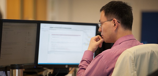 IT developer with multiple computer terminals